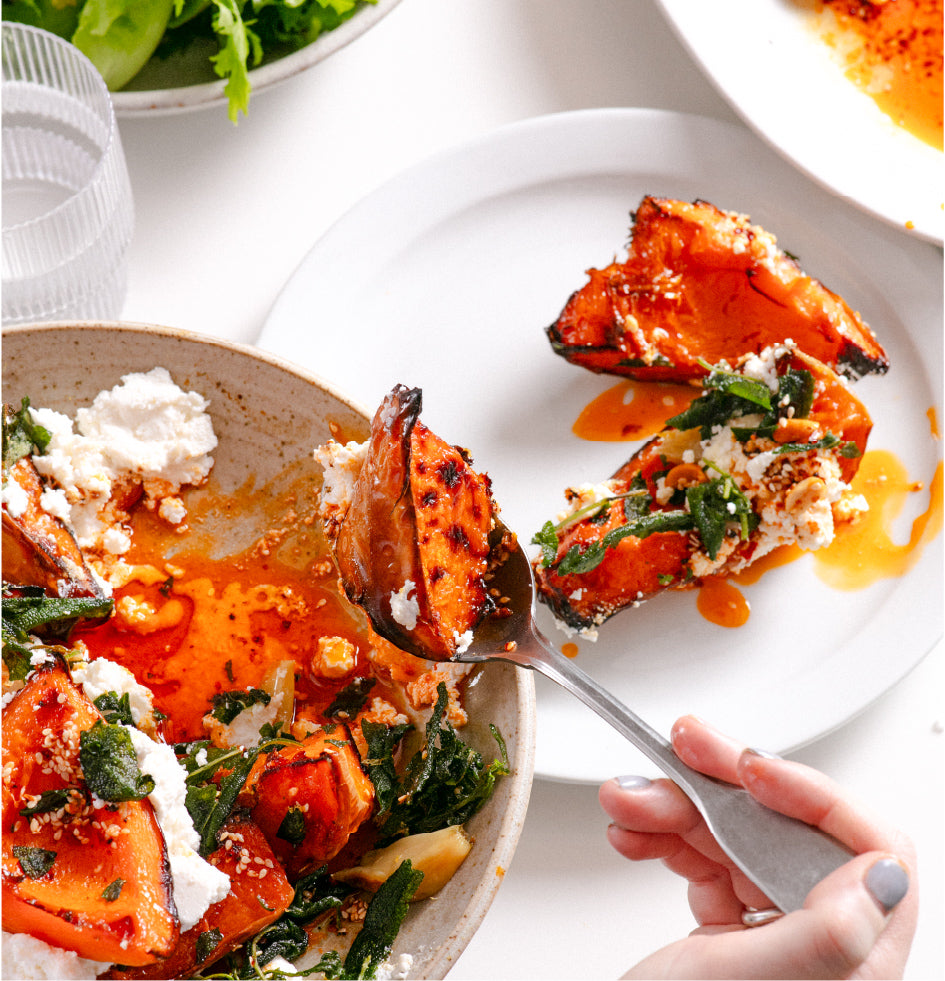 A series of plates containing sweet potato, cheese and green leaves covered in White Mausu peanut rāyu